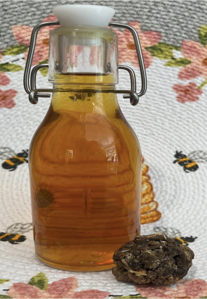 Small bottle of clear golden liquid which is a propolis Tincture